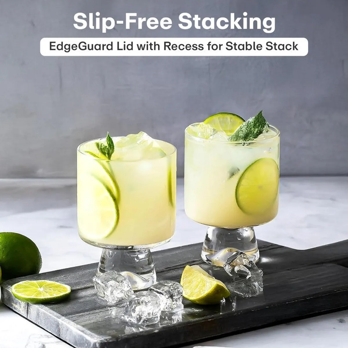 Two clear footed glasses with lime drinks on a serving tray