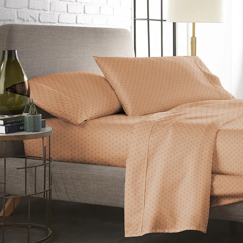 Peach dotted duvet cover and pillows styled on a modern bed