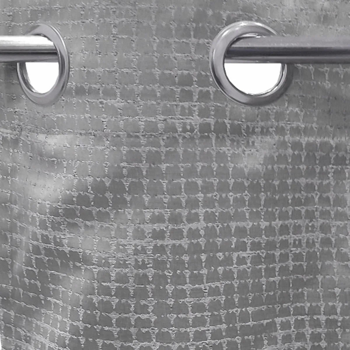 Close-up of silver eyelets on the grey textured curtain