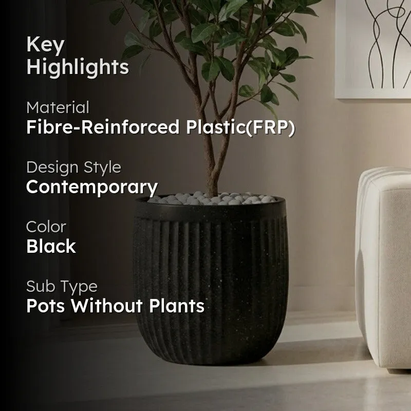 Black ribbed planter with plant in a contemporary living room setting