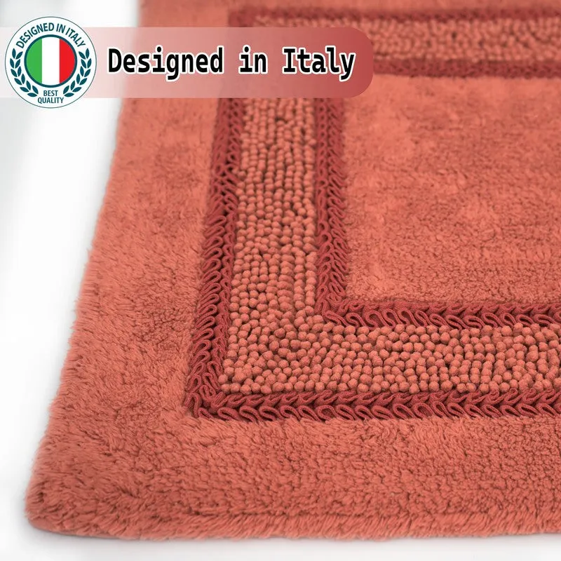 Close-up view of the orange mat's soft textured pile and geometric border
