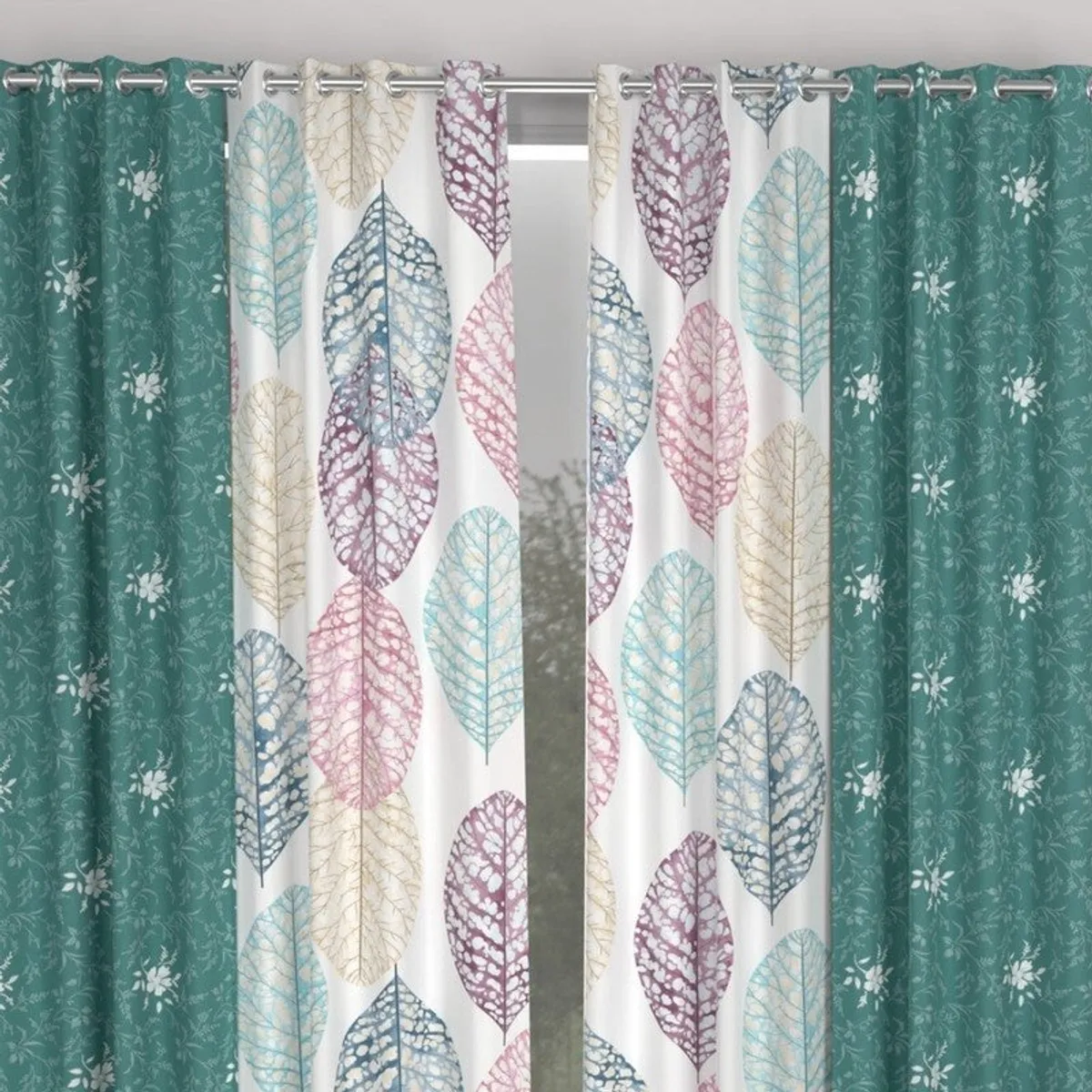 Close view of teal and multicolour leaf-print curtains with eyelet tops