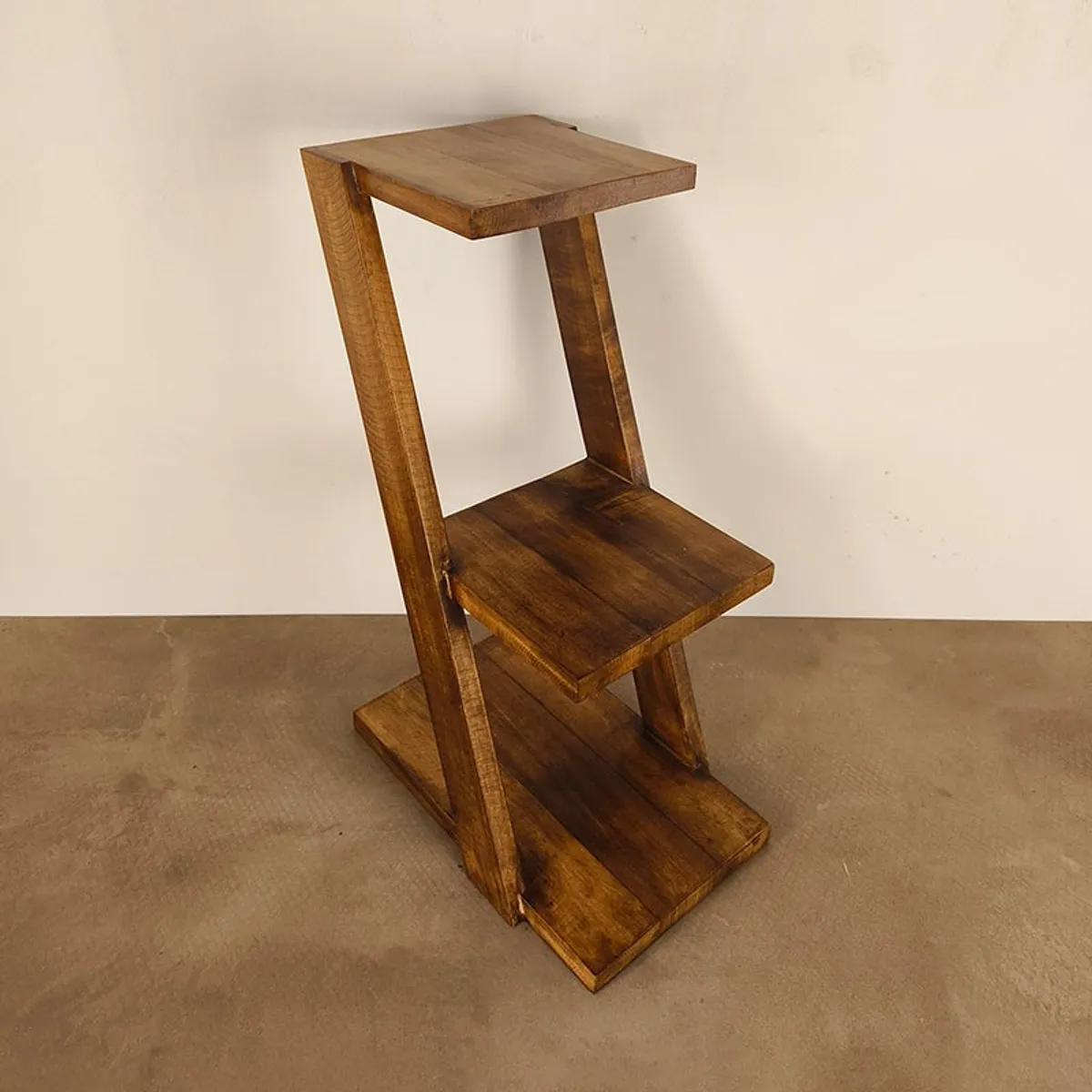Empty brown three-tier wooden rack with angled side supports