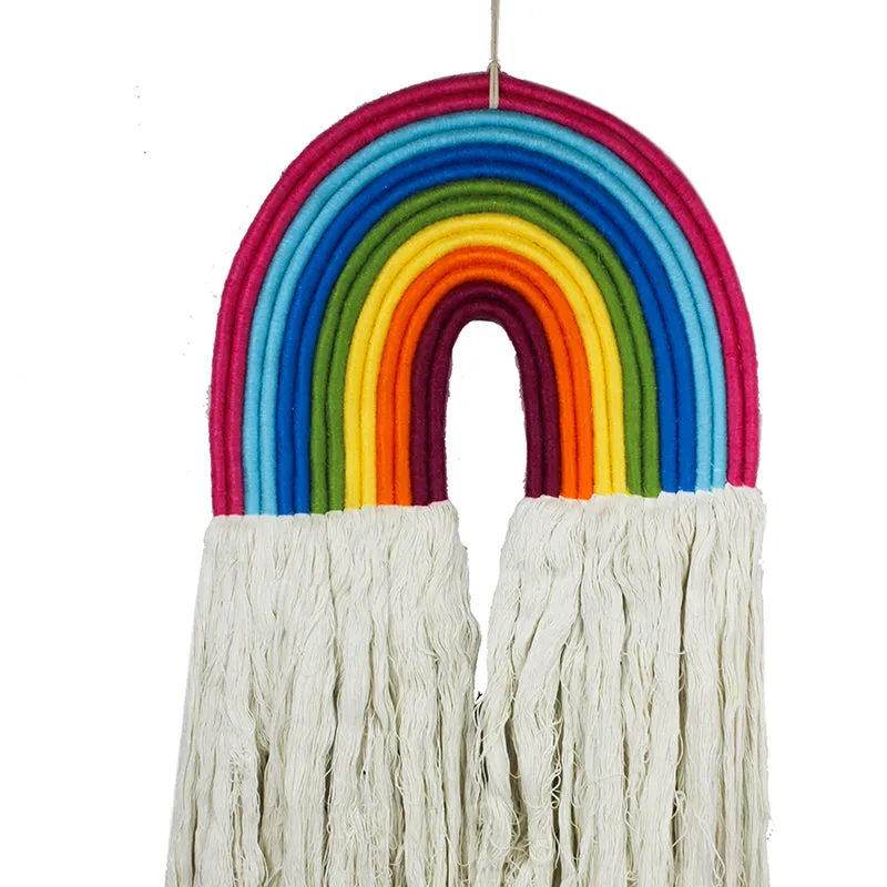 Close-up view of the vibrant rainbow arch and cream tassels