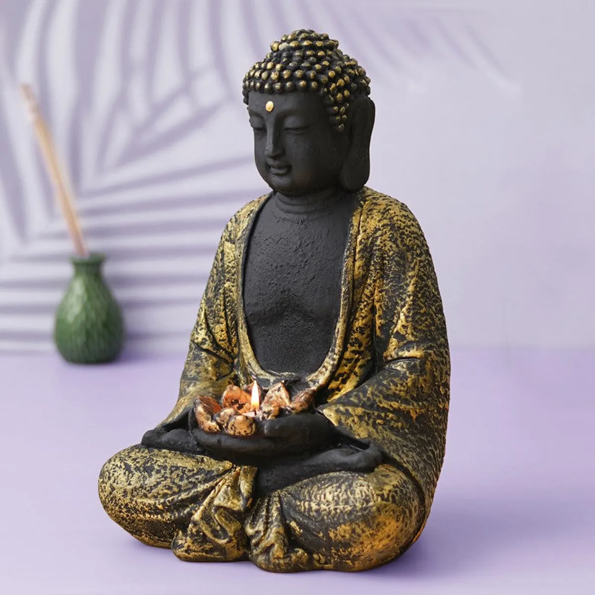 Side angle of Buddha tea light candle holder with lit tea light