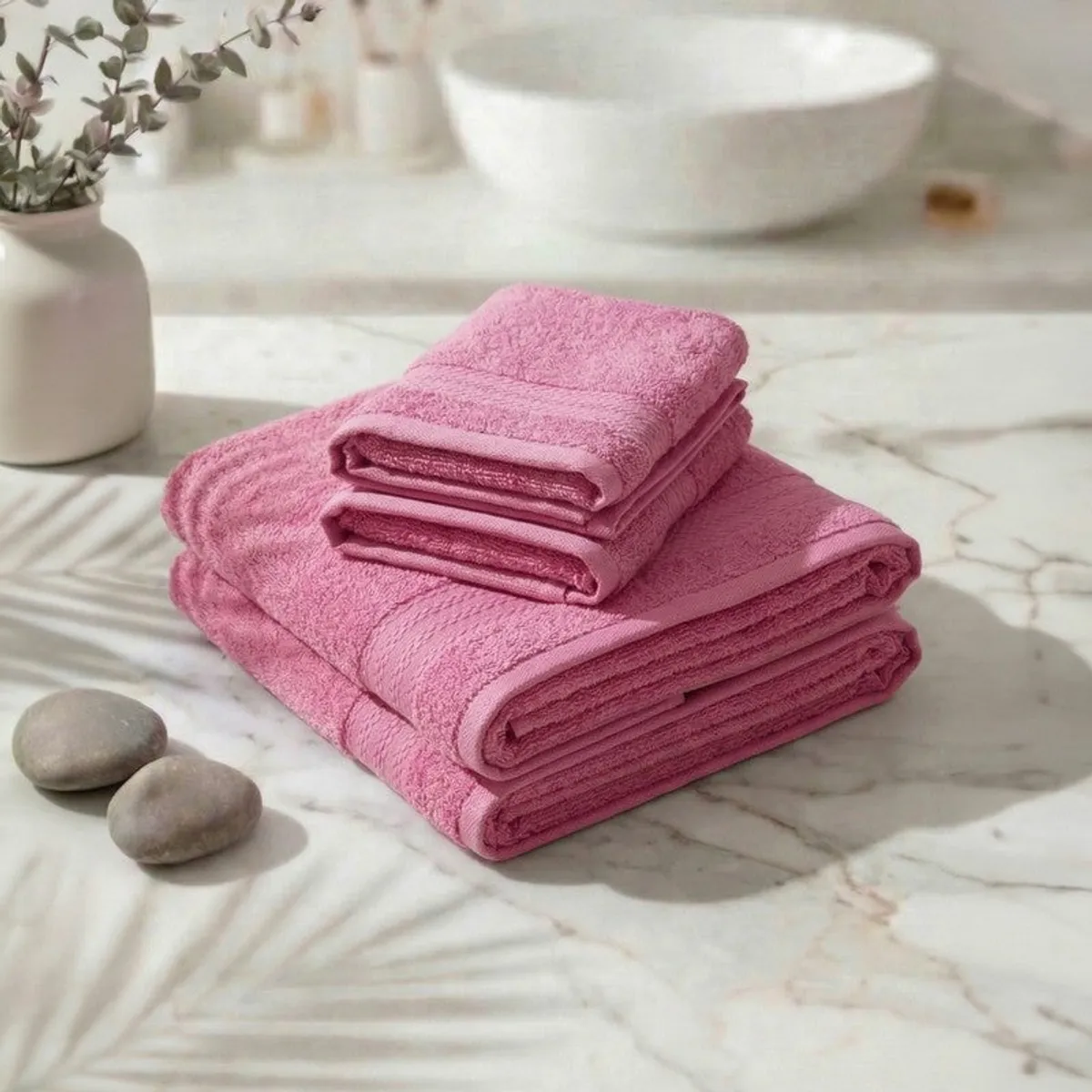 Stack of pink towels on a marble surface