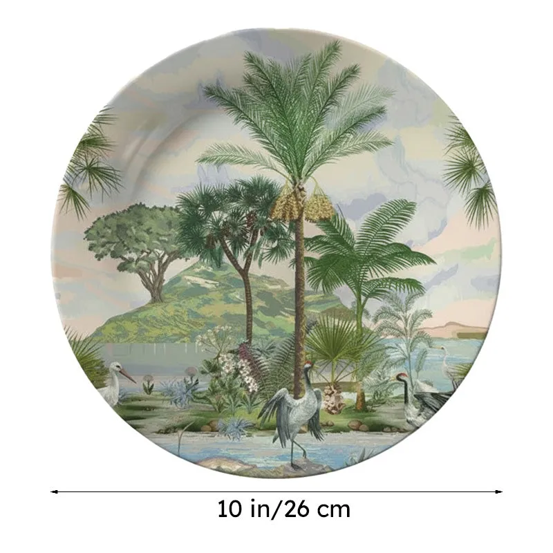 Close-up of round plate with palm trees, water and wading cranes