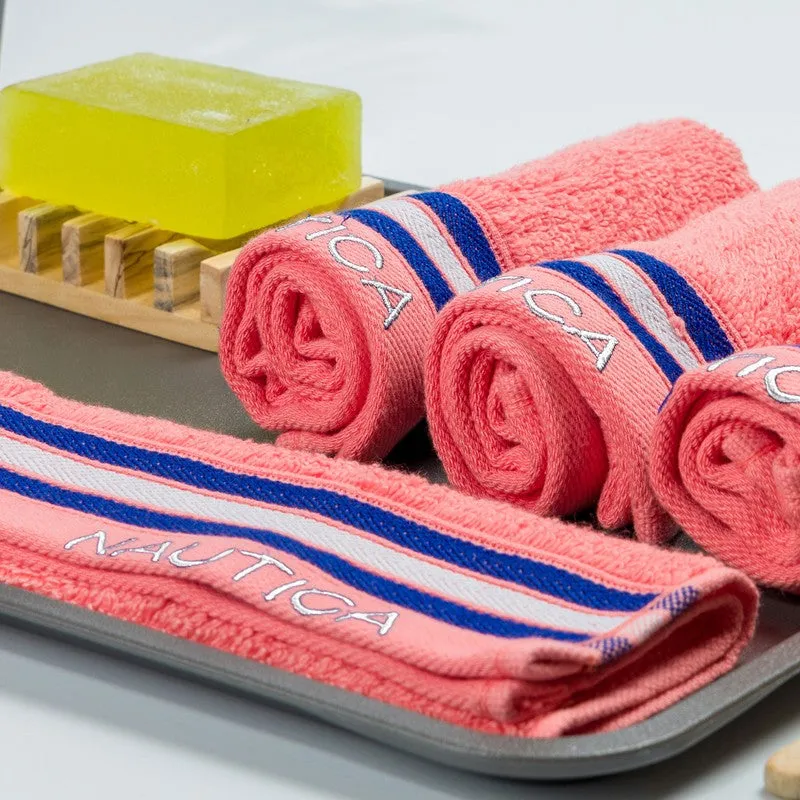 Close-up of rolled orange towels with striped border detail