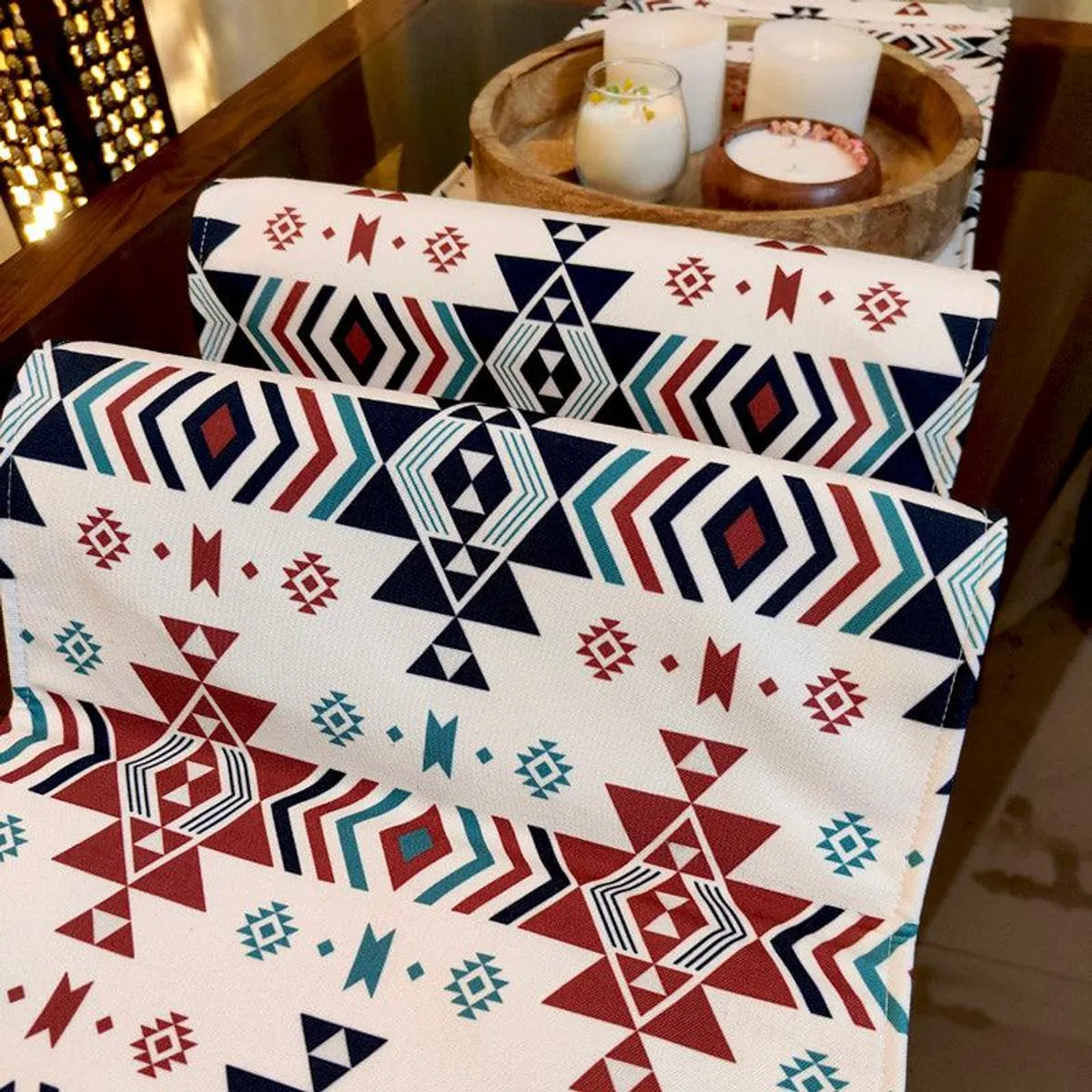 Close view of geometric red, navy and teal table runner pattern