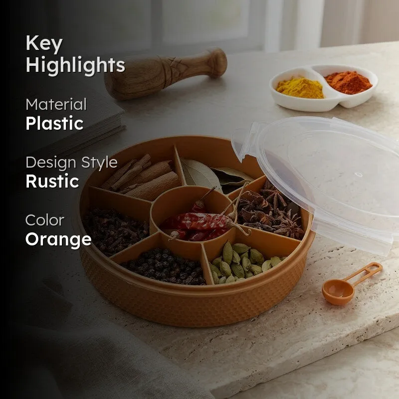 Orange masala box with clear lid and multiple spice compartments in a kitchen setting