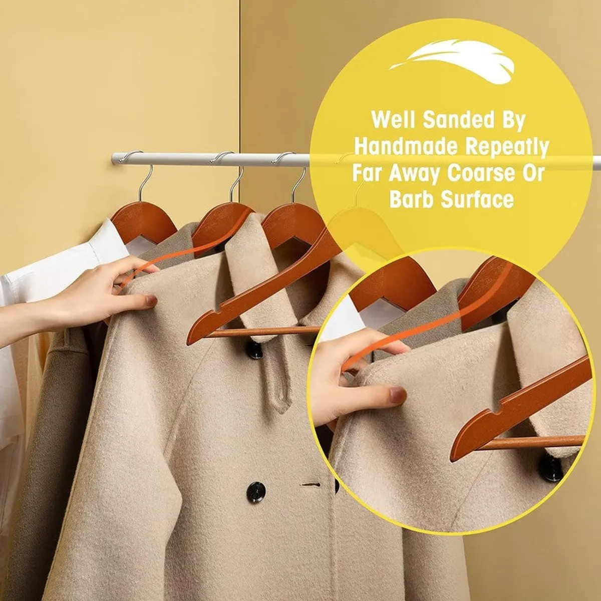 Brown wooden hangers holding coats and garments on a rail