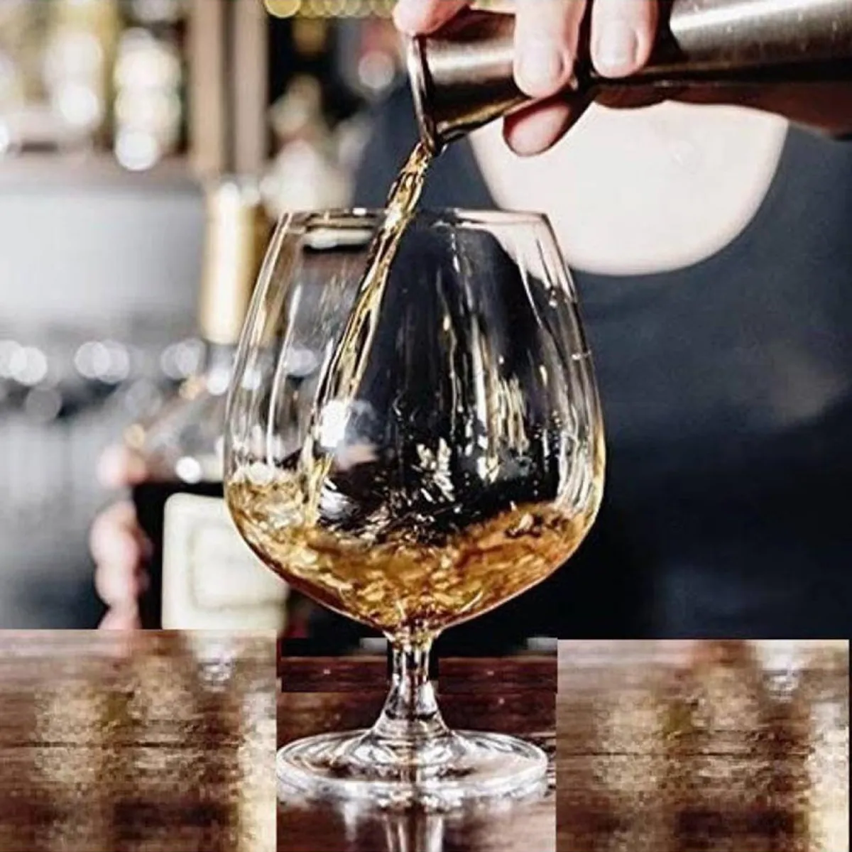 Transparent snifter glass being filled with an amber drink