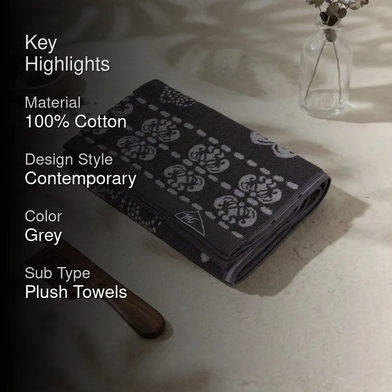 Grey folded bath towel with key highlights text overlay