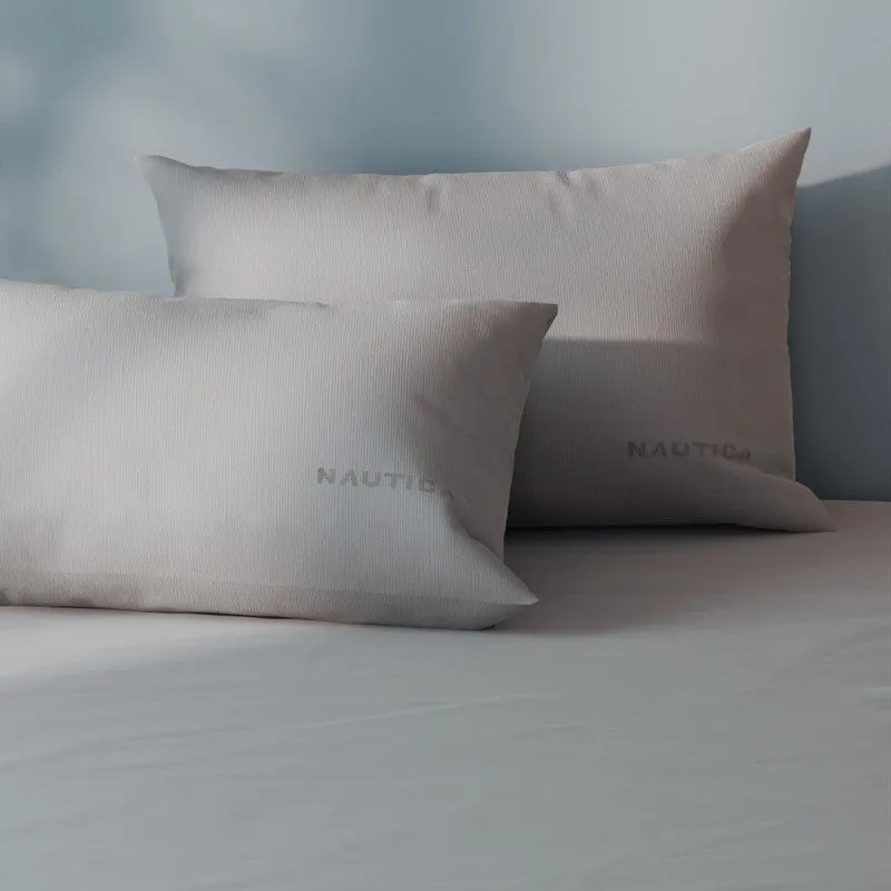 Silver-grey bedding and pillow covers photographed in soft natural light
