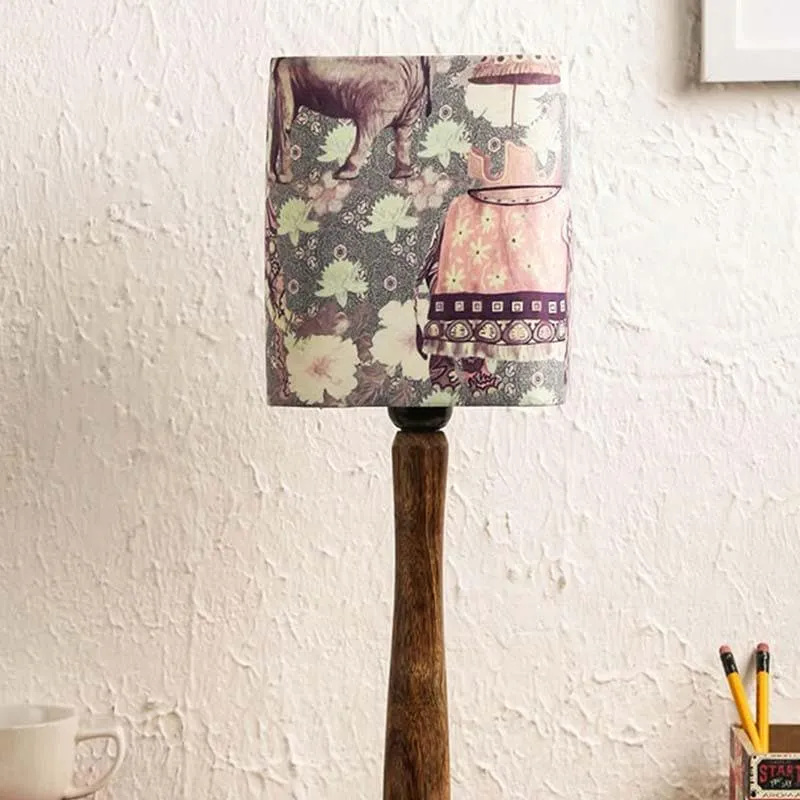 Lit table lamp with printed fabric shade and slim wooden base