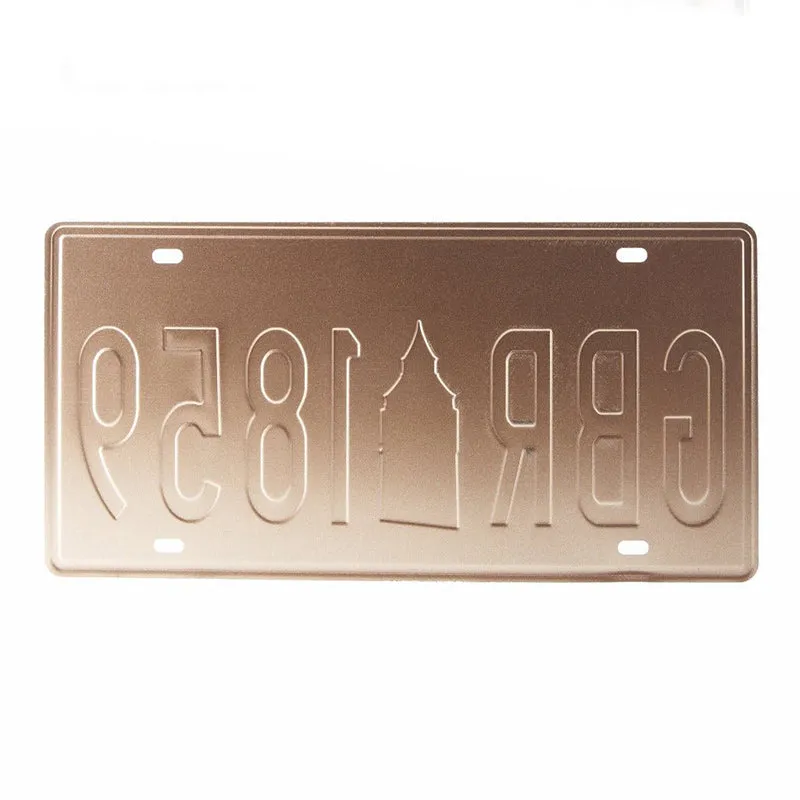 Embossed metal wall accent with numbers and tower silhouette in a slim rectangular frame