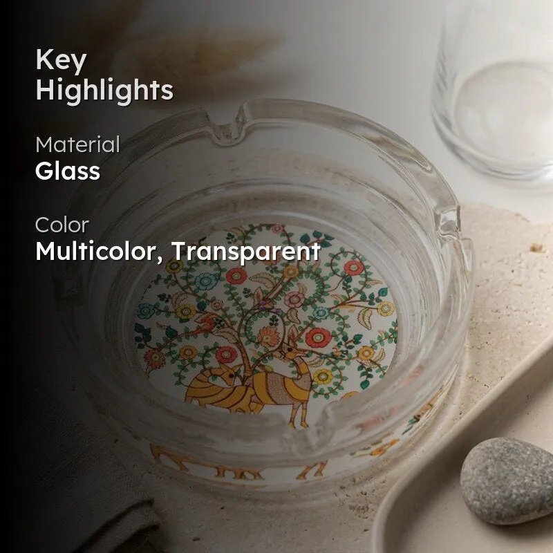Transparent glass ashtray with multicolour artwork shown in a lifestyle image