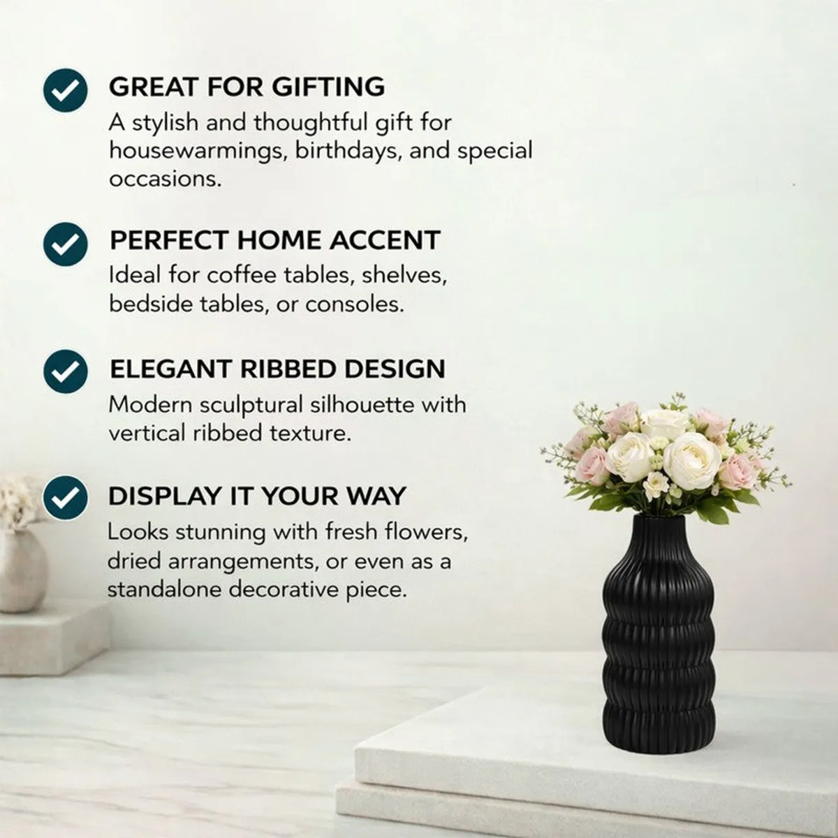 Black ribbed vase with a white floral arrangement on a pedestal