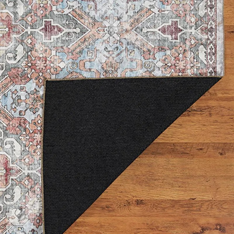 Carpet corner folded back to show black underside on wooden floor