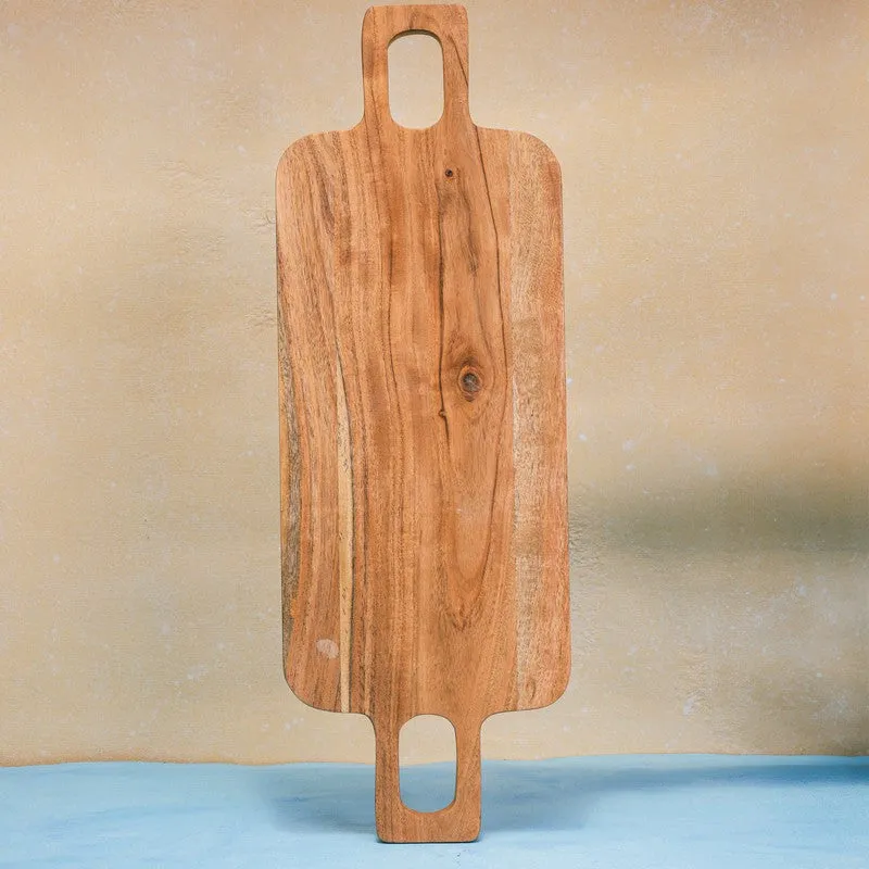 Brown wooden chopping board shown vertically to reveal its long shape and handles