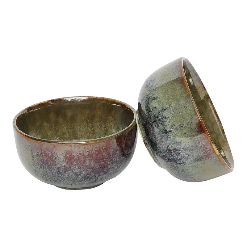 Two glossy ceramic bowls showing their rounded shape and mottled earthy glaze