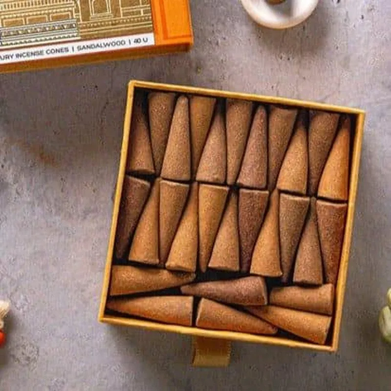 Close-up of brown incense cones arranged inside an open box