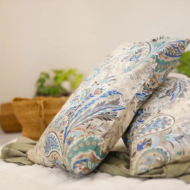 Blue and beige paisley duvet cover arranged with pillows