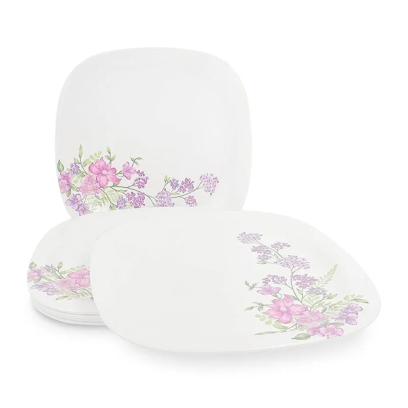 White square floral dinner plates arranged in a layered tabletop display
