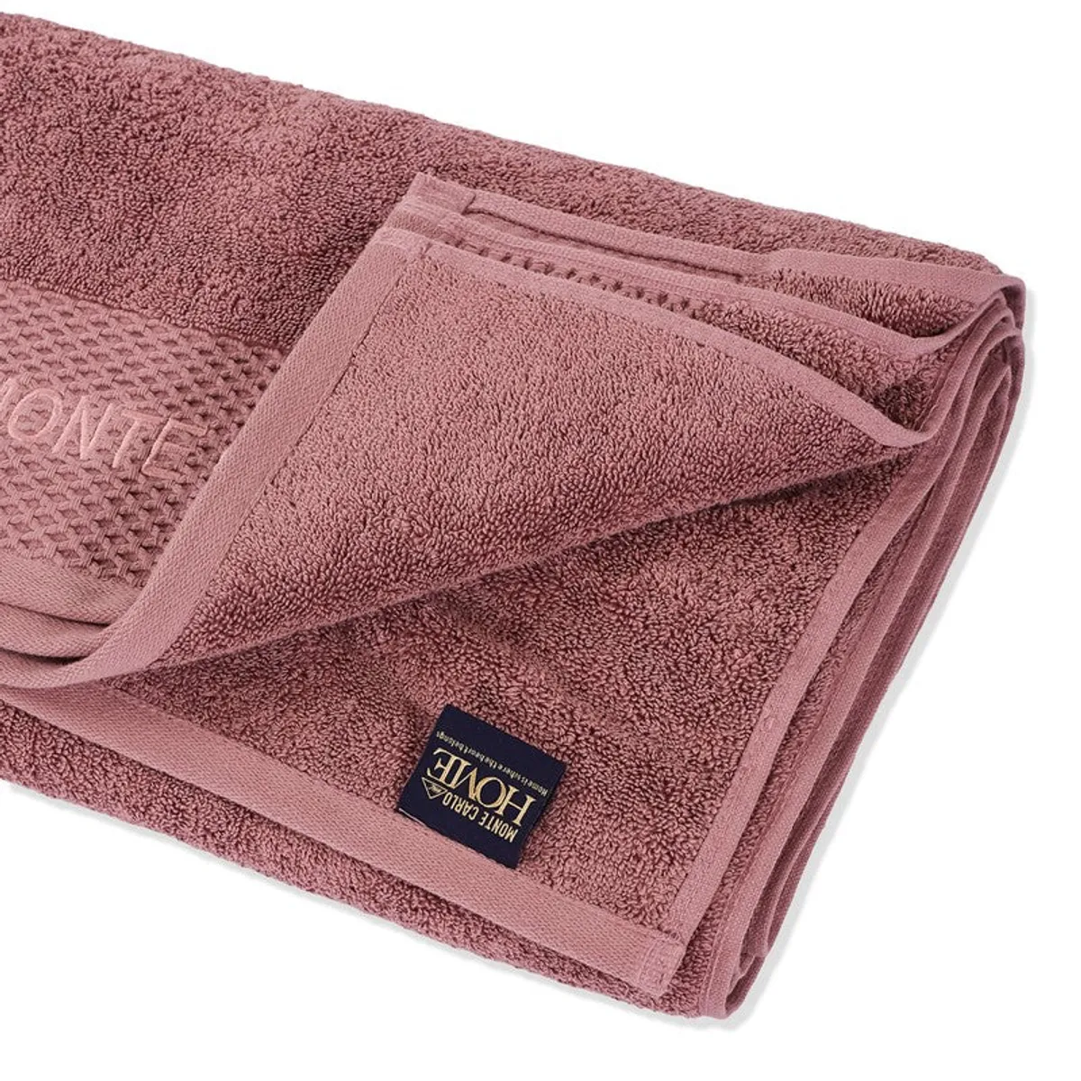 Close-up of the towel's soft pile, border and folded corner