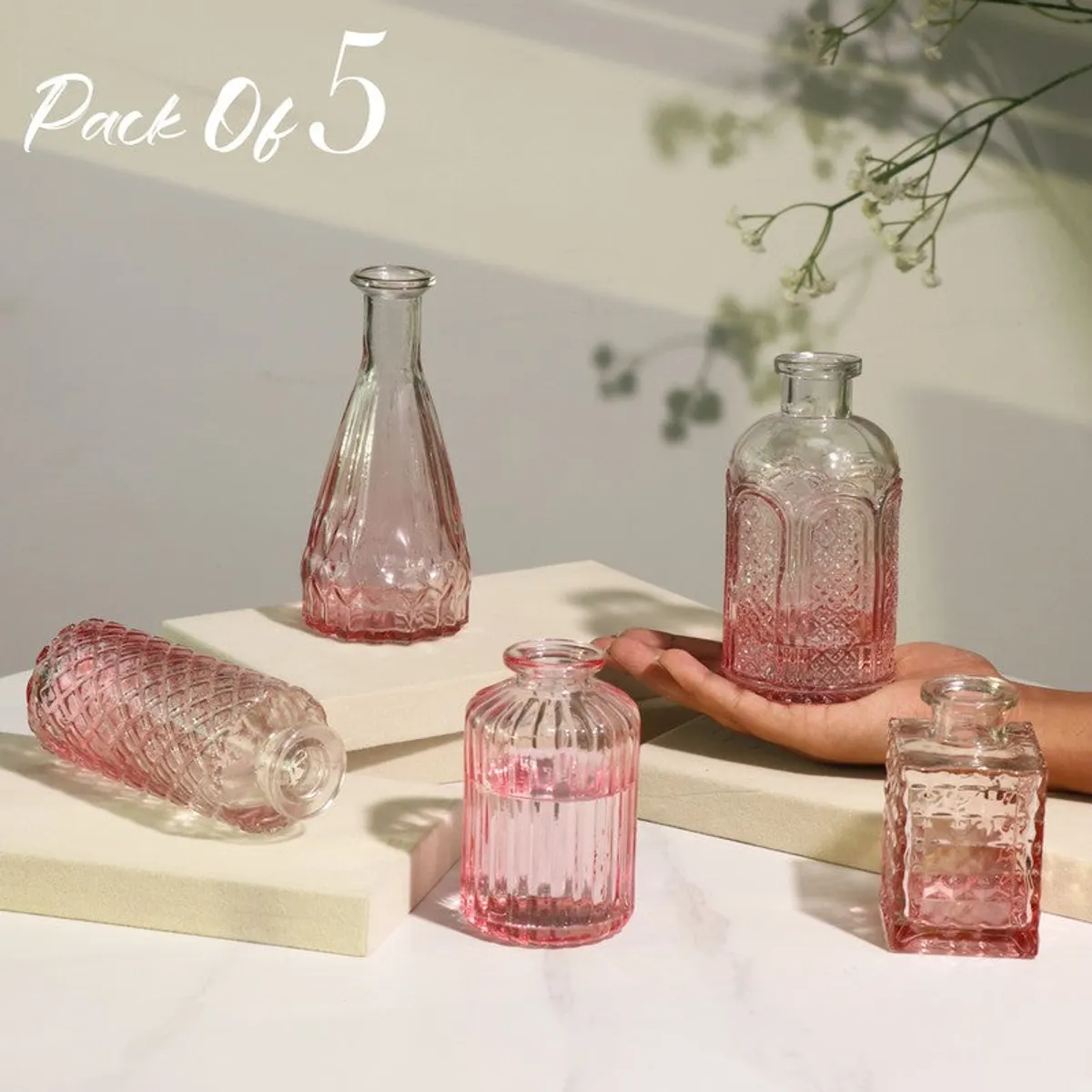 Pack of five pink glass vases in assorted shapes