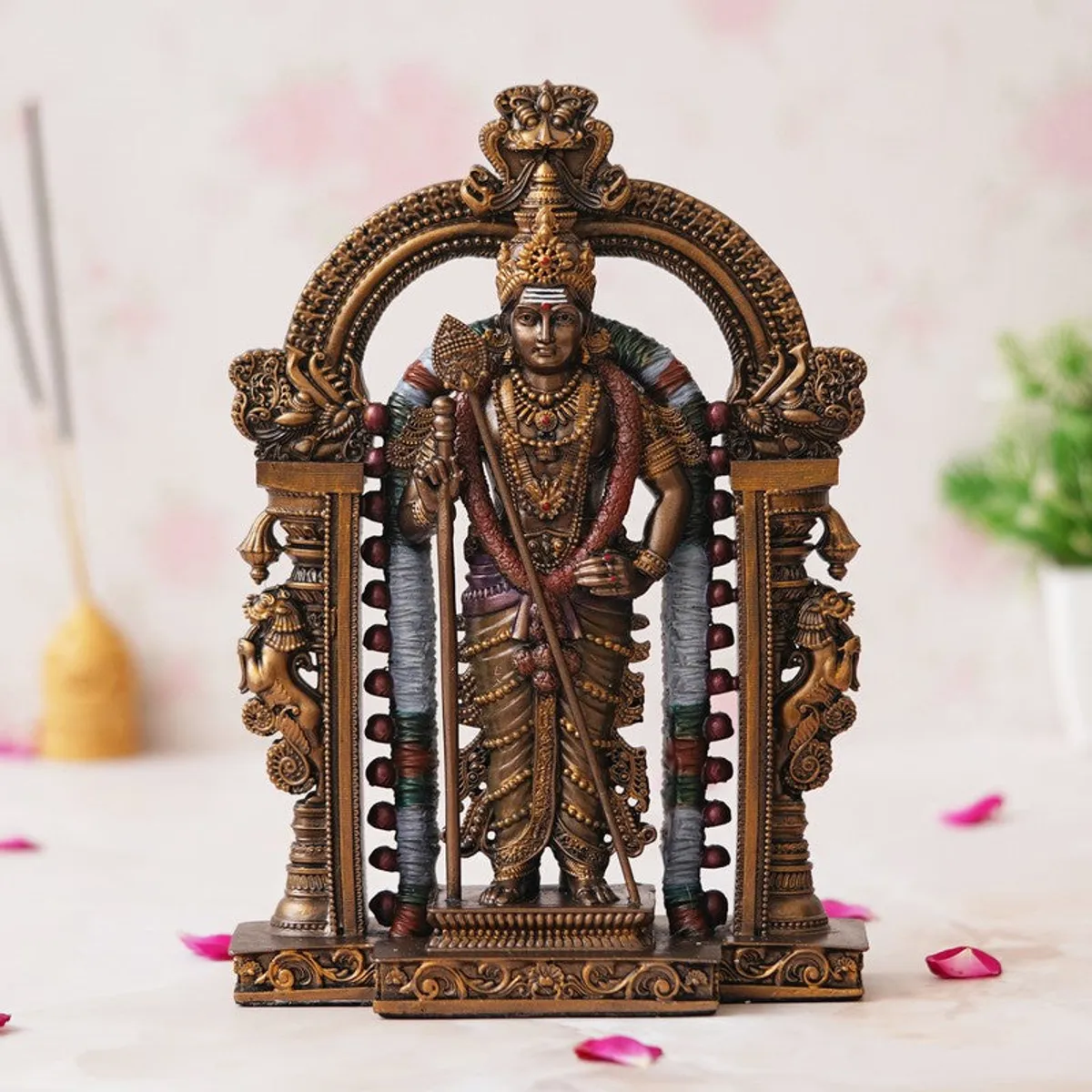 Vel Murugan idol displayed beneath an ornate decorative arch