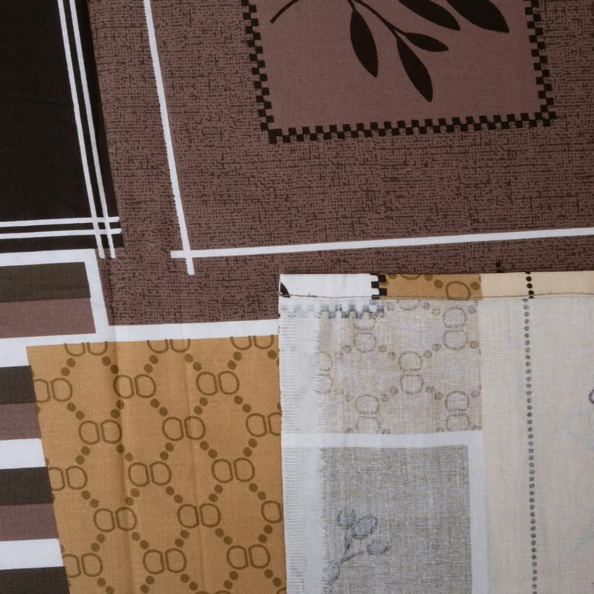 Detailed view of brown and beige geometric printed bedsheet fabric