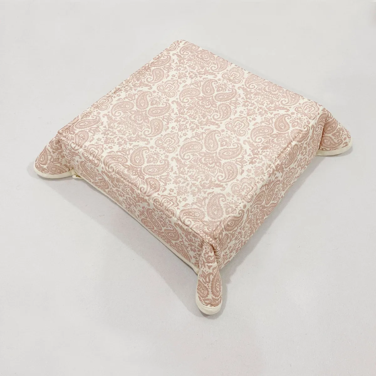 Foldable square beige bread basket with printed exterior and corner ties