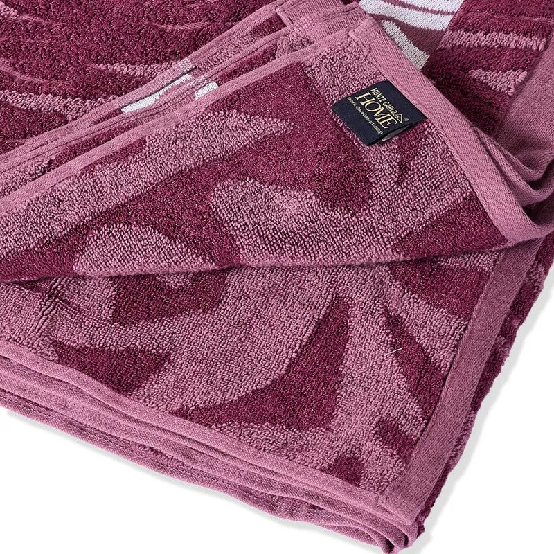Close-up of the towel's plush maroon and pink textured floral surface.