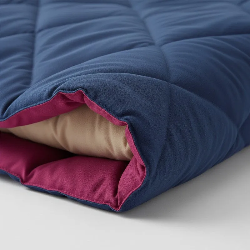 Close-up of the blue and pink quilted comforter layers and soft filling