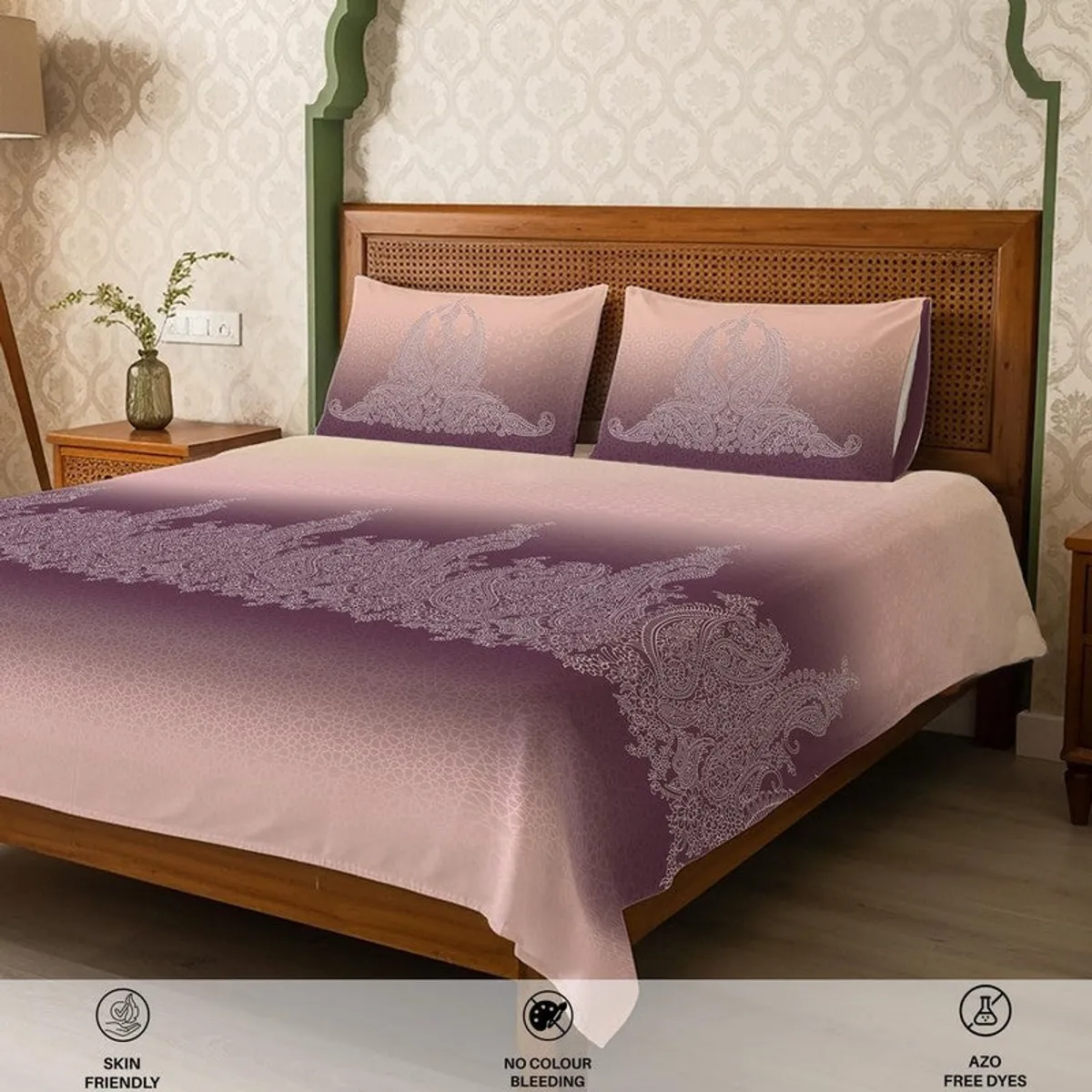 Angled view of pink and purple ombre bedsheet with intricate ornamental pattern