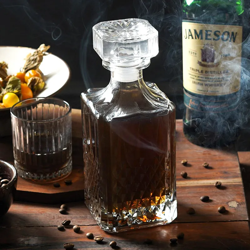 Crystal glass decanter with square stopper and textured base on a wooden table