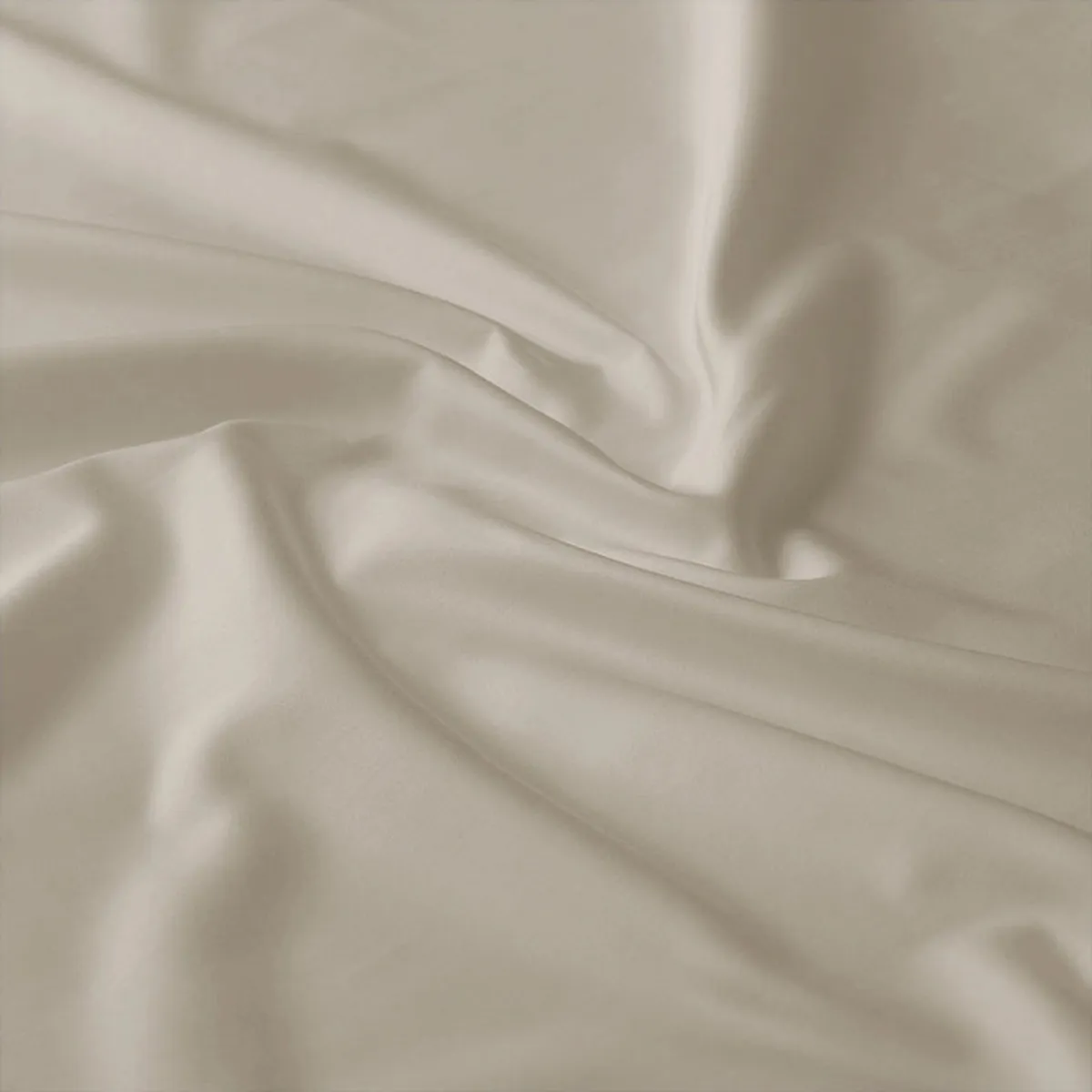 Close-up of the beige bedsheet fabric showing soft folds