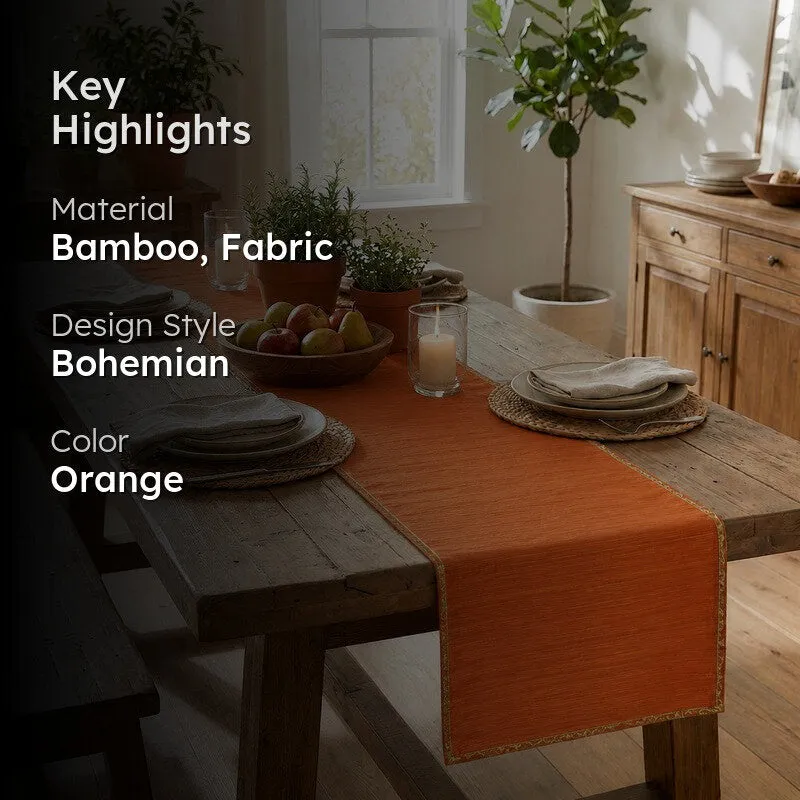 Orange table runner styled on a dining table in a bright room