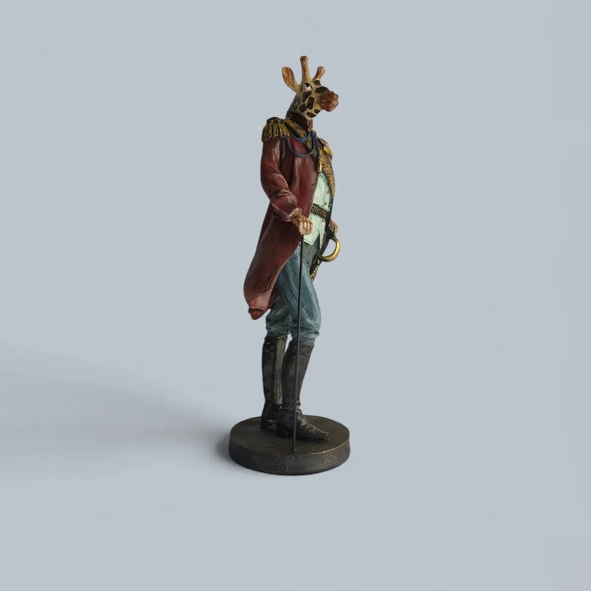 Side view of the decorative figurine on a round base against a plain light background.
