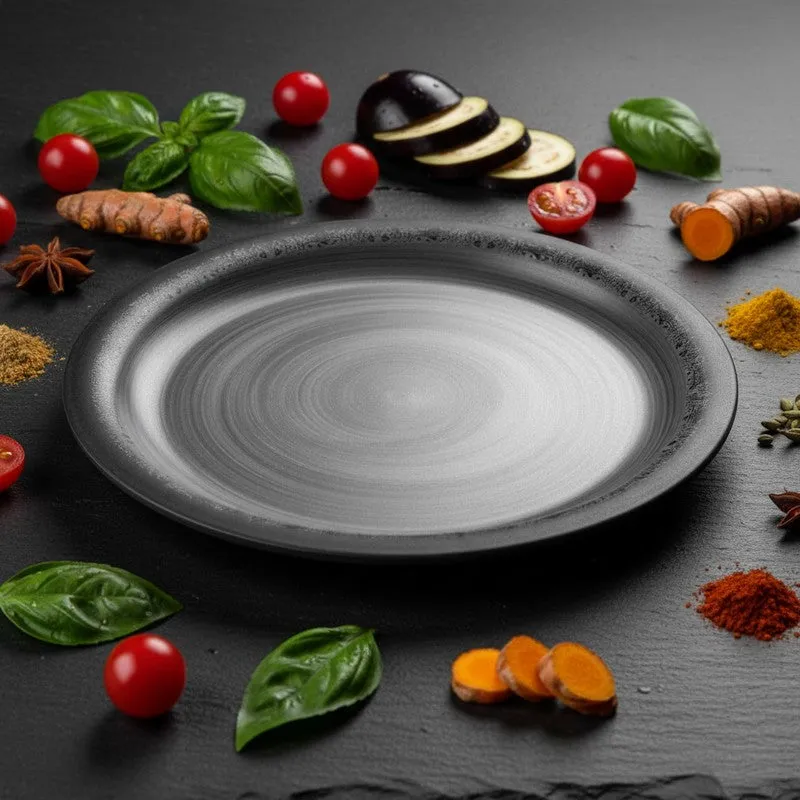 Black and grey dinner plate styled with vegetables and spices