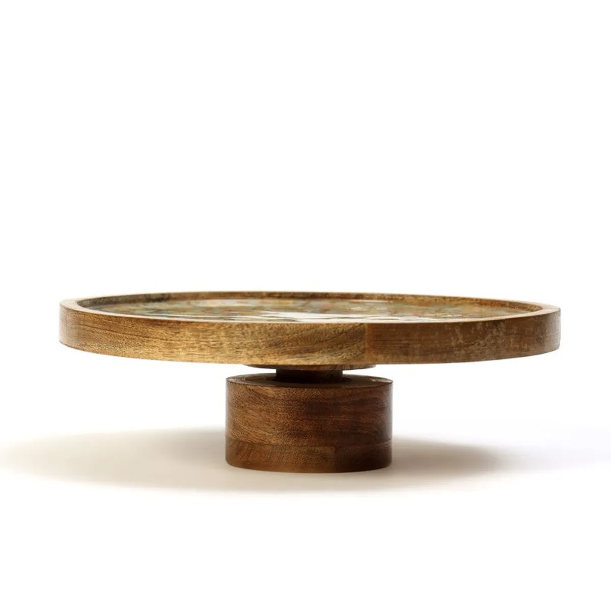 Side view of a round mango wood cake stand with a raised pedestal base