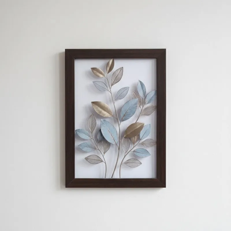 Framed botanical artwork with layered blue, silver and beige leaves