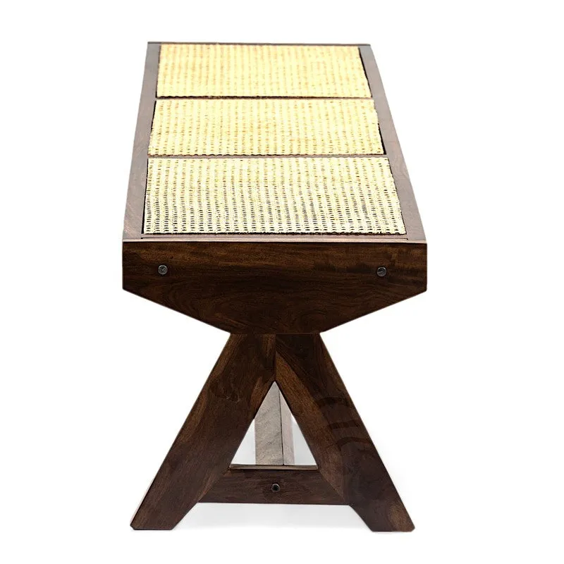 End view of wooden bench with beige woven cane top