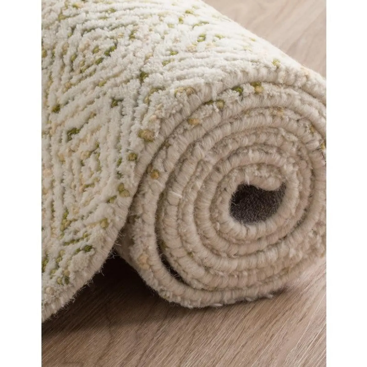 Close-up of the rug rolled to show its soft textured pile