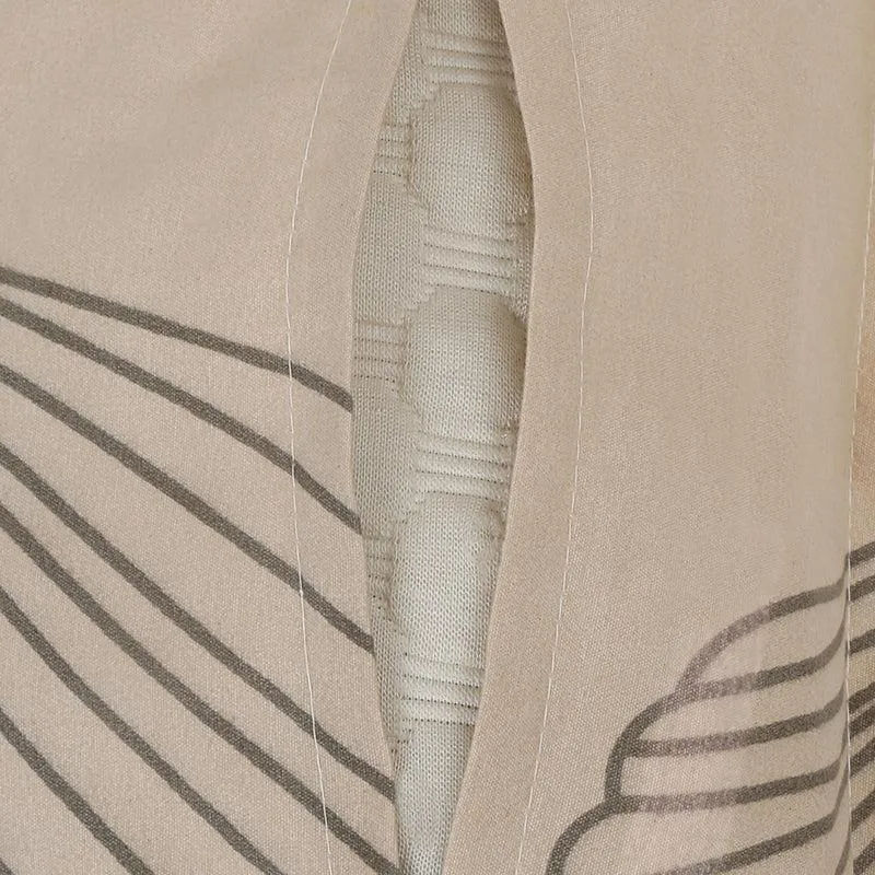 Close-up of pillow cover opening on beige printed fabric