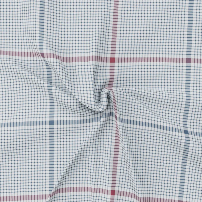 Close-up showing the soft drape and fine checked weave of the bedsheet