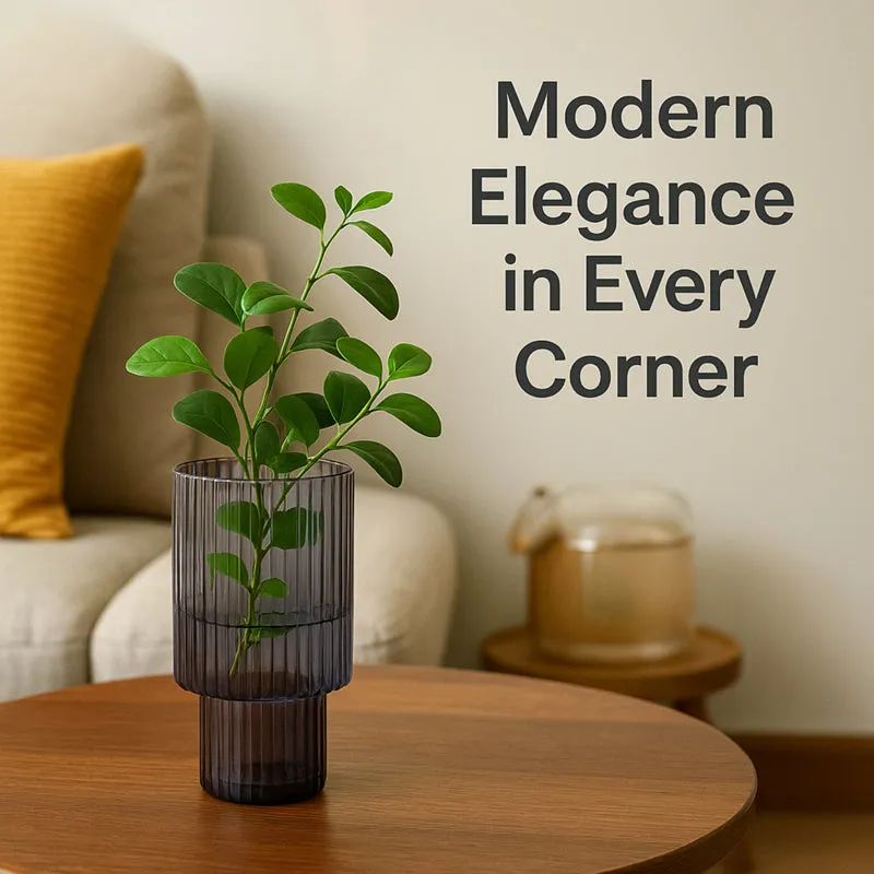 Grey ribbed glass vase with green stems styled on a round table