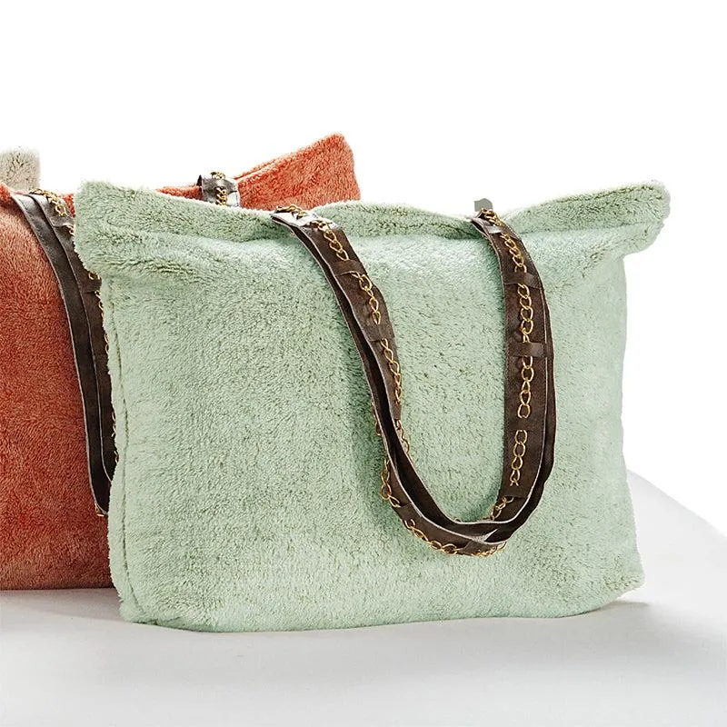 Folded green dohar placed inside a tote bag