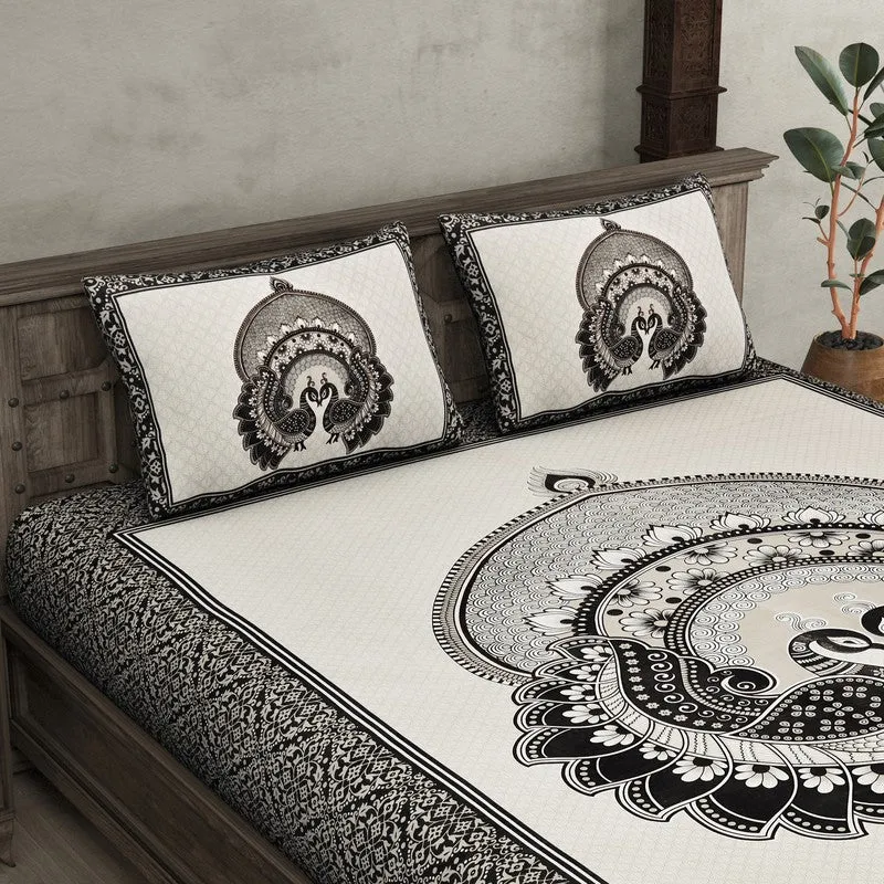 Close view of black and white bedsheet and pillow covers with peacock design